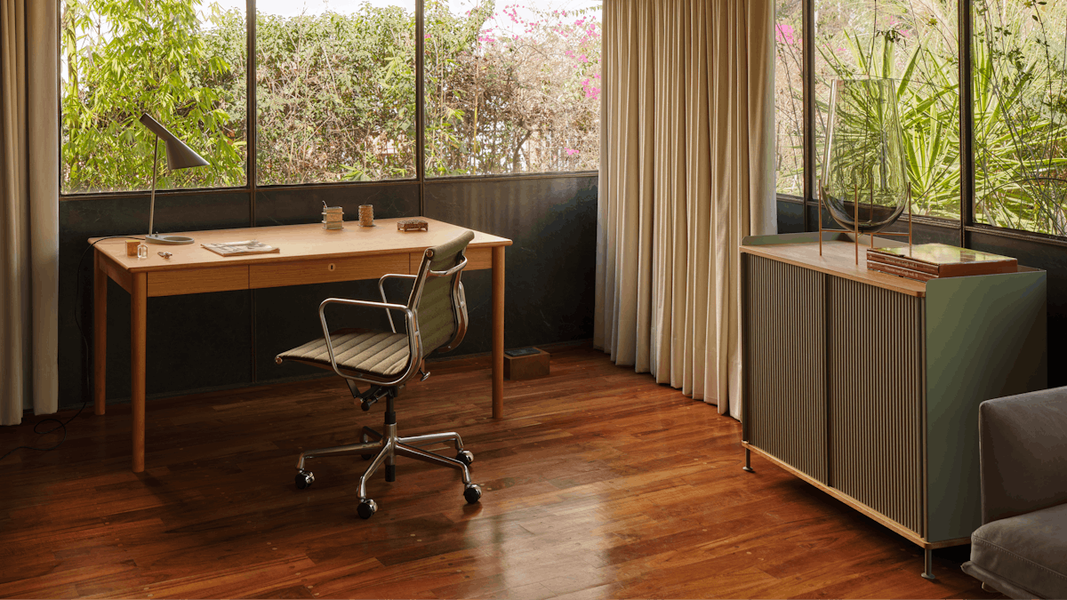 Edel Desk, Eames Aluminum Group Chair and Enfold Sideboard in a home office setting